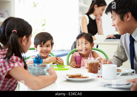 Asian Family Having Breakfast Before Husband Goes To Work Stock Photo