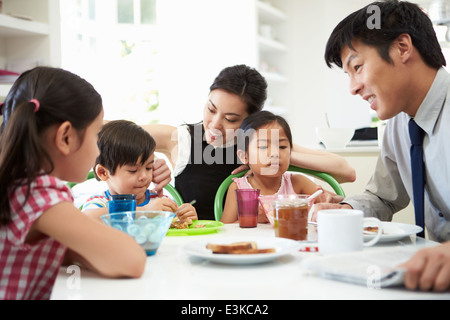 Asian Family Having Breakfast Before Husband Goes To Work Stock Photo