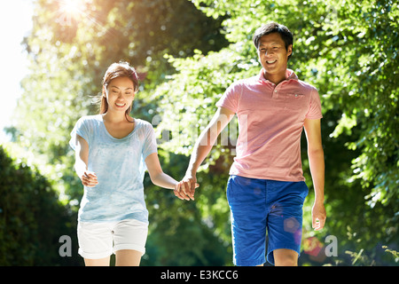 Romantic Asian Couple On Walk In Countryside Stock Photo