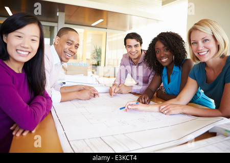 Group Of Architects Discussing Plans In Modern Office Stock Photo