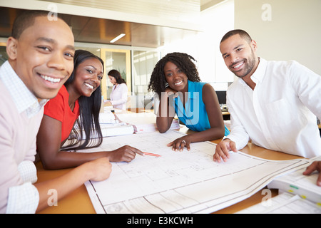 Group Of Architects Discussing Plans In Modern Office Stock Photo