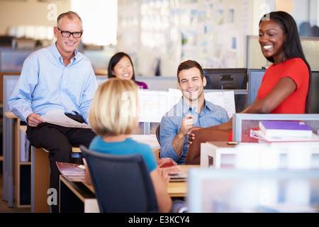 Businesspeople Having Meeting In Modern Open Plan Office Stock Photo