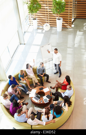 Businessman Making Presentation To Office Colleagues Stock Photo