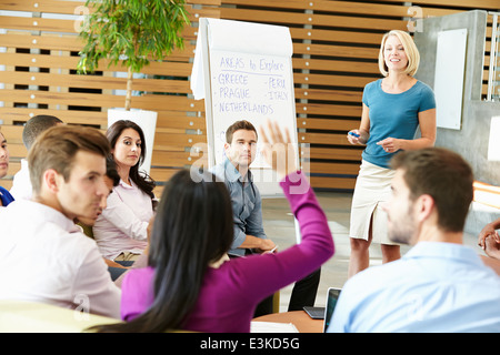 Businesswoman Making Presentation To Office Colleagues Stock Photo