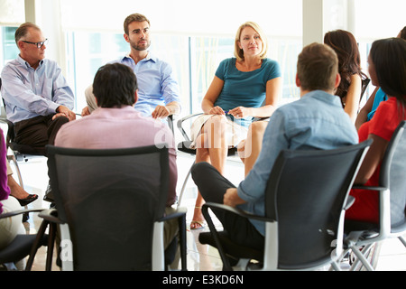 Multi-Cultural Office Staff Sitting Having Meeting Together Stock Photo
