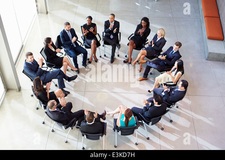 Multi-Cultural Office Staff Applauding During Meeting Stock Photo