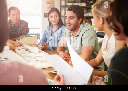 Six Architects Sitting Around Table Having Meeting Stock Photo