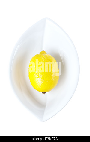 Ripe yellow lemon in white plate isolated on a white background Stock Photo