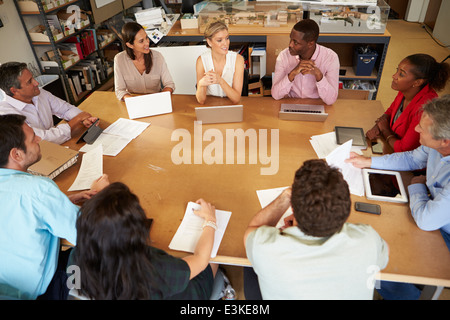 Architects Sitting At Table Meeting With Laptops And Tablets Stock Photo
