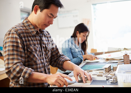 Male Architect Working On Model In Office Stock Photo