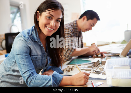 Female Architect Working On Model In Office Stock Photo