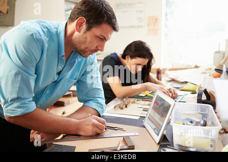 Two Architects Making Models In Office Using Digital Tablet Stock Photo