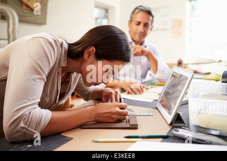 Two Architects Making Models In Office Using Digital Tablet Stock Photo