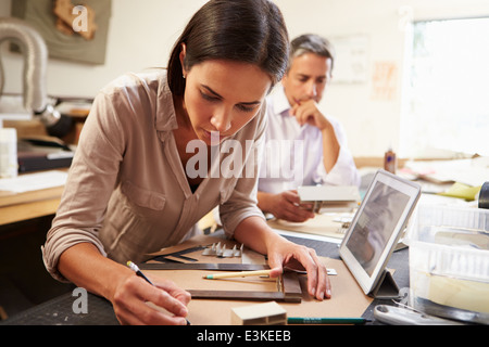 Two Architects Making Models In Office Using Digital Tablet Stock Photo