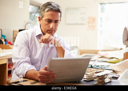 Architect Making Model In Office Using Digital Tablet Stock Photo