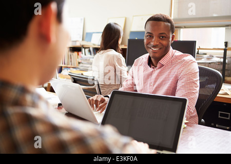 Male Architect Working At Desk On Laptop Stock Photo