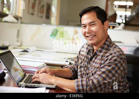 Male Architect Working At Desk On Laptop Stock Photo
