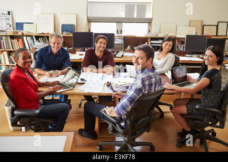 Group Of Architects Meeting Around Desk Stock Photo