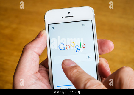 detail of Google search engine app homepage on iPhone smart phone Stock Photo