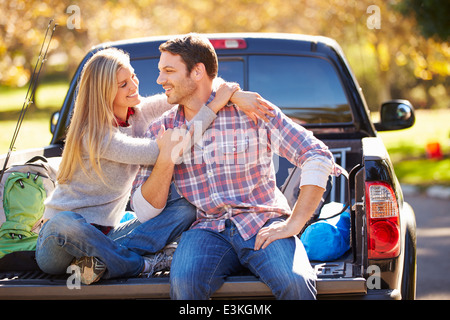 Couple Sitting In Pick Up Truck On Camping Holiday Stock Photo