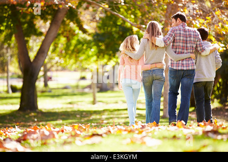 Rear View Of Family Walking Through Autumn Woodland Stock Photo