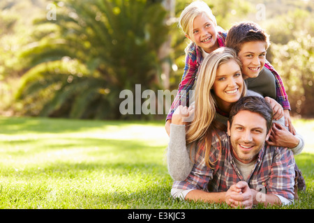 Portrait Of Family Lying On Grass In Countryside