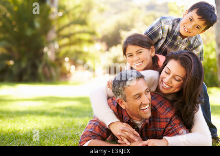 Family Lying On Grass In Countryside Stock Photo