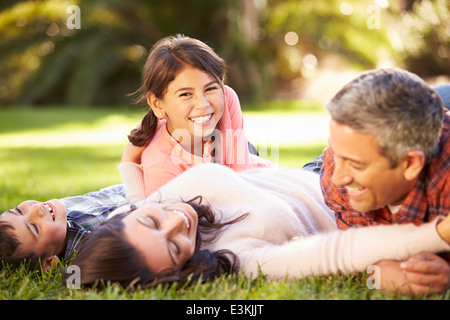 Family Lying On Grass In Countryside Stock Photo