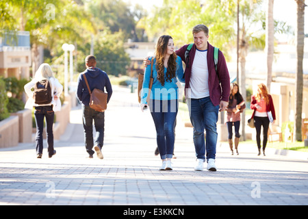 Student Couple Walking Outdoors On University Campus Stock Photo