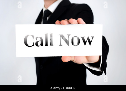 Businessman showing card with call now Stock Photo