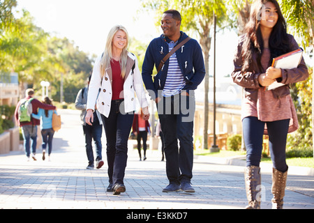 Students Walking Outdoors On University Campus Stock Photo