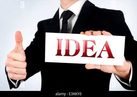 Businessman showing idea word on card Stock Photo