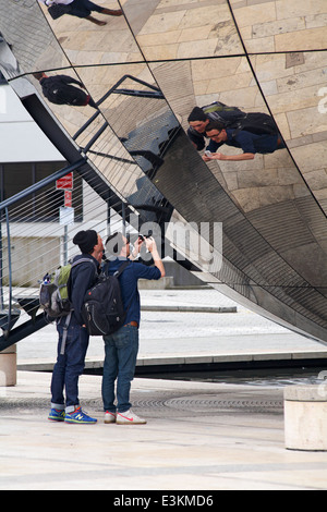 taking a photo of reflections in mirrored planetarium sphere at Millenium Square, Harbourside, Bristol in May Stock Photo