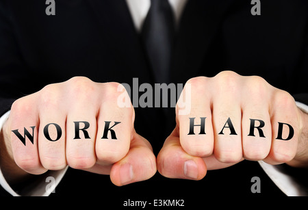 Business man showing work hard word on fist Stock Photo