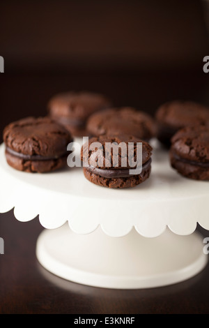 Chocolate Cream Cookies on White Enamel Cake Stand Stock Photo