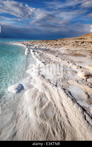 View of the Dead sea landscape with mineral structures on the shore and desert mountains in the background Stock Photo