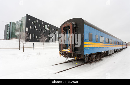 Train Transport and Physics with the Perimeter Institute. An old Via Rail car parked on a siding at the new Perimeter Institute Stock Photo