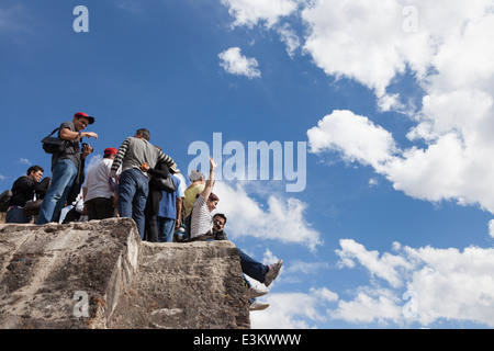 Group of young tourists gathered on el Tepozteco Pyramid - Tepoztlán, Morelos, Mexico Stock Photo