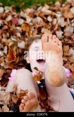 Picture of pre teen girl showing dirty feet Stock Photo