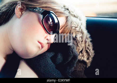 Picture of teenage girl (13-15) sleeping in car Stock Photo
