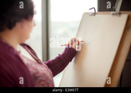 Picture of young woman drawing on canvas, Massachusetts, USA Stock Photo