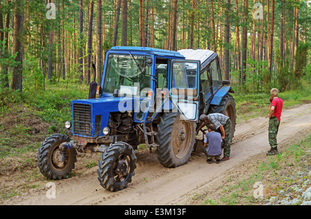 Tractor breakage in the wood. The tractor plowed a furrow dividing forest places at a firestorm. Stock Photo