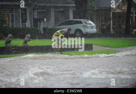 Ft. Worth, Tx, USA. 24th June, 2014. 6/24/2014. A Ft. Worth firefighter tries to check if a flooded car is still occupied as thunder storms and heavy rains hit north Texas causing flash flooding in neighborhood streets in Ft. Worth Tx. Credit:  Ralph Lauer/ZUMAPRESS.com/Alamy Live News Stock Photo