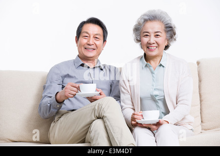 Senior couple having tea in living room Stock Photo