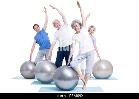 Senior adults practicing yoga Stock Photo