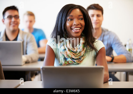 Female University Student Using Laptop In Classroom Stock Photo