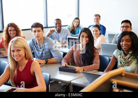 University Students Using Digital Tablet And Laptop In Class Stock Photo