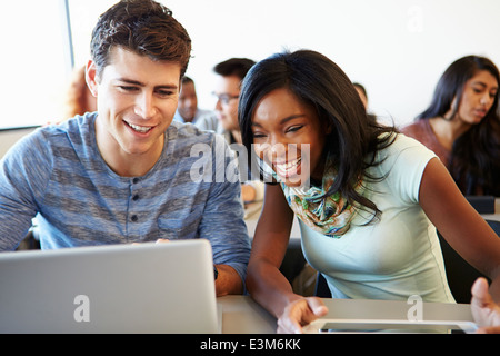 University Students Using Digital Tablet And Laptop In Class Stock Photo