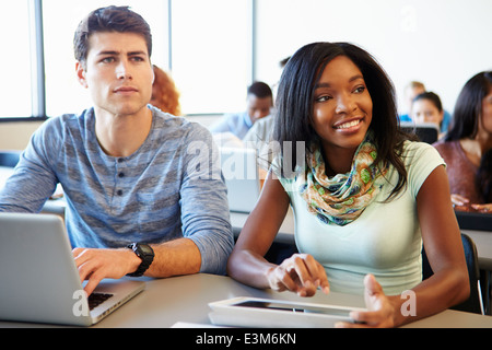 University Students Using Digital Tablet And Laptop In Class Stock Photo