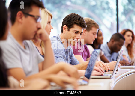 Class Of University Students Using Laptops In Lecture Stock Photo